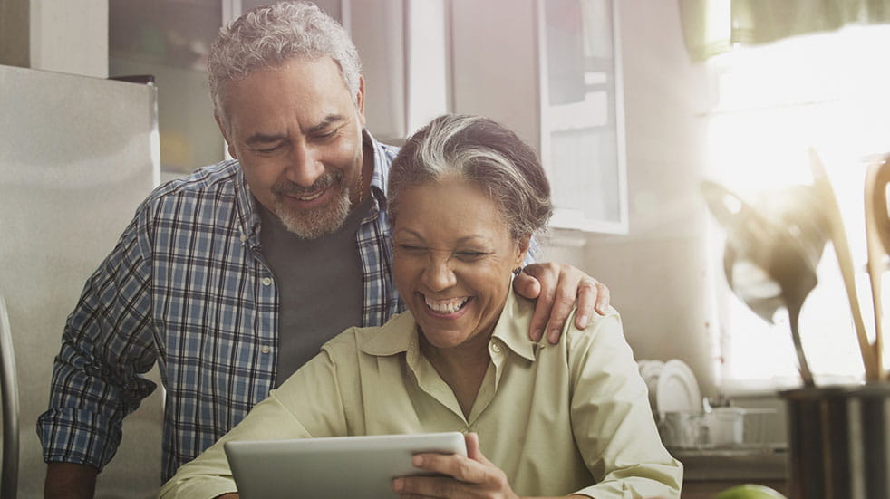 25 free things to do at home; couple chatting on tablet